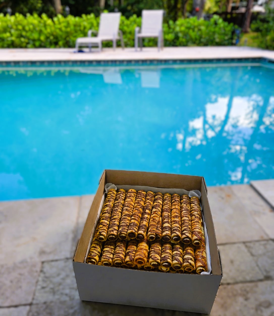 Large LOCO Choco crêpe box photographed beside a swimming pool